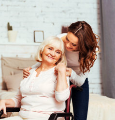 caregiver and senior woman hugging each other